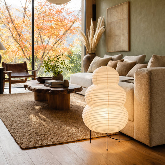 Cocoon™ Paper Table Lamp glowing beside the boucle sofa in the Calm Eden living room
