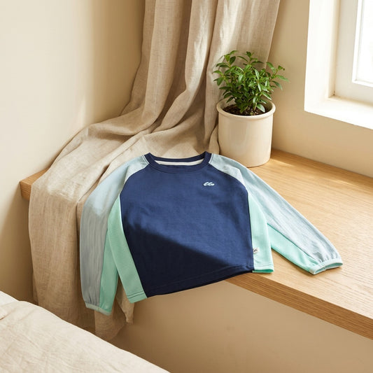 Sunsleeve™ Kids Long Sleeve Sun Protection Shirt in a calm home setting