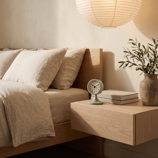 Sage Tock™ clock on a floating oak nightstand in a Japandi bedroom