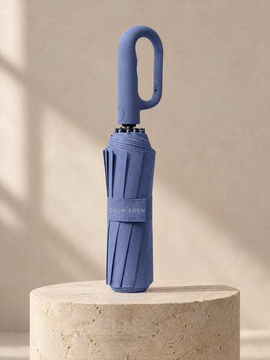 Blue Haven umbrella, folded, on a stone plinth