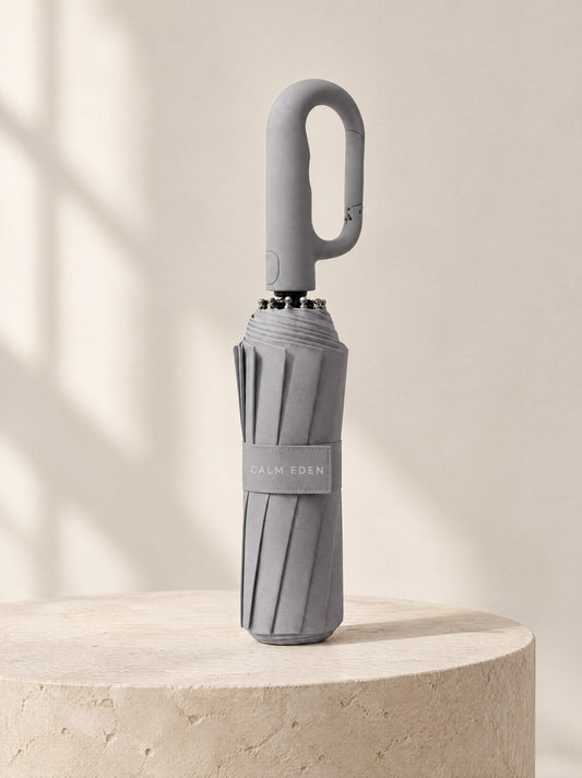 Gray Haven umbrella, folded, on a stone plinth