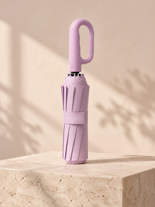 Pink Haven umbrella, folded, on a stone plinth