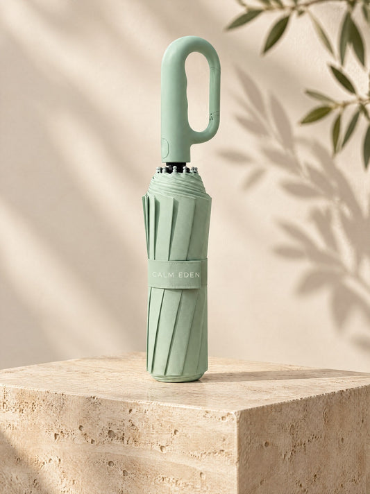 Green Haven umbrella, folded, on a stone plinth