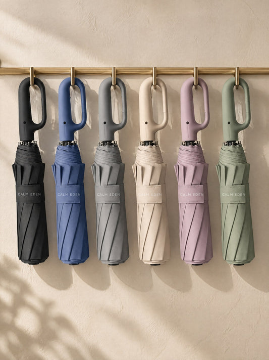 Haven umbrellas in six of the seven colours hanging on a rail by their carabiner handles