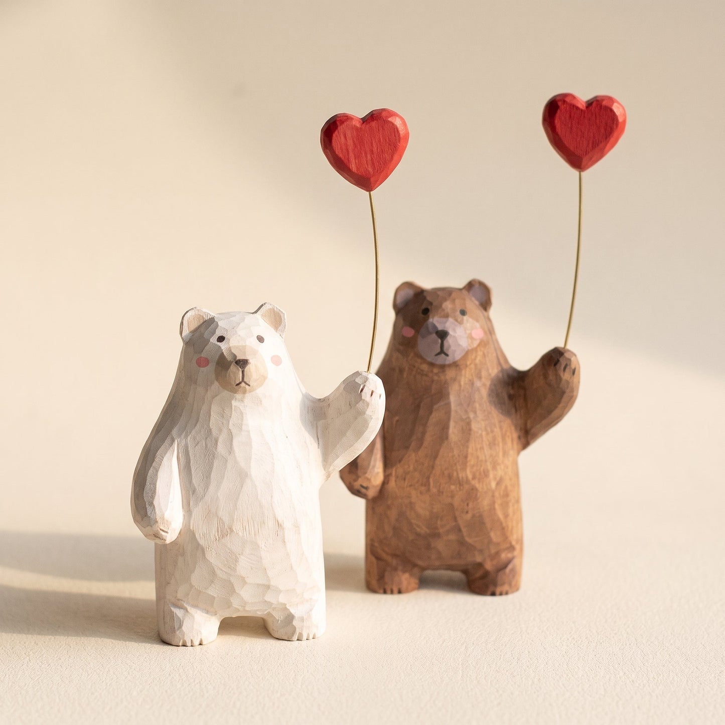 Bruin™ Carved Bear Ornament — white and walnut hand-carved bears on warm cream background