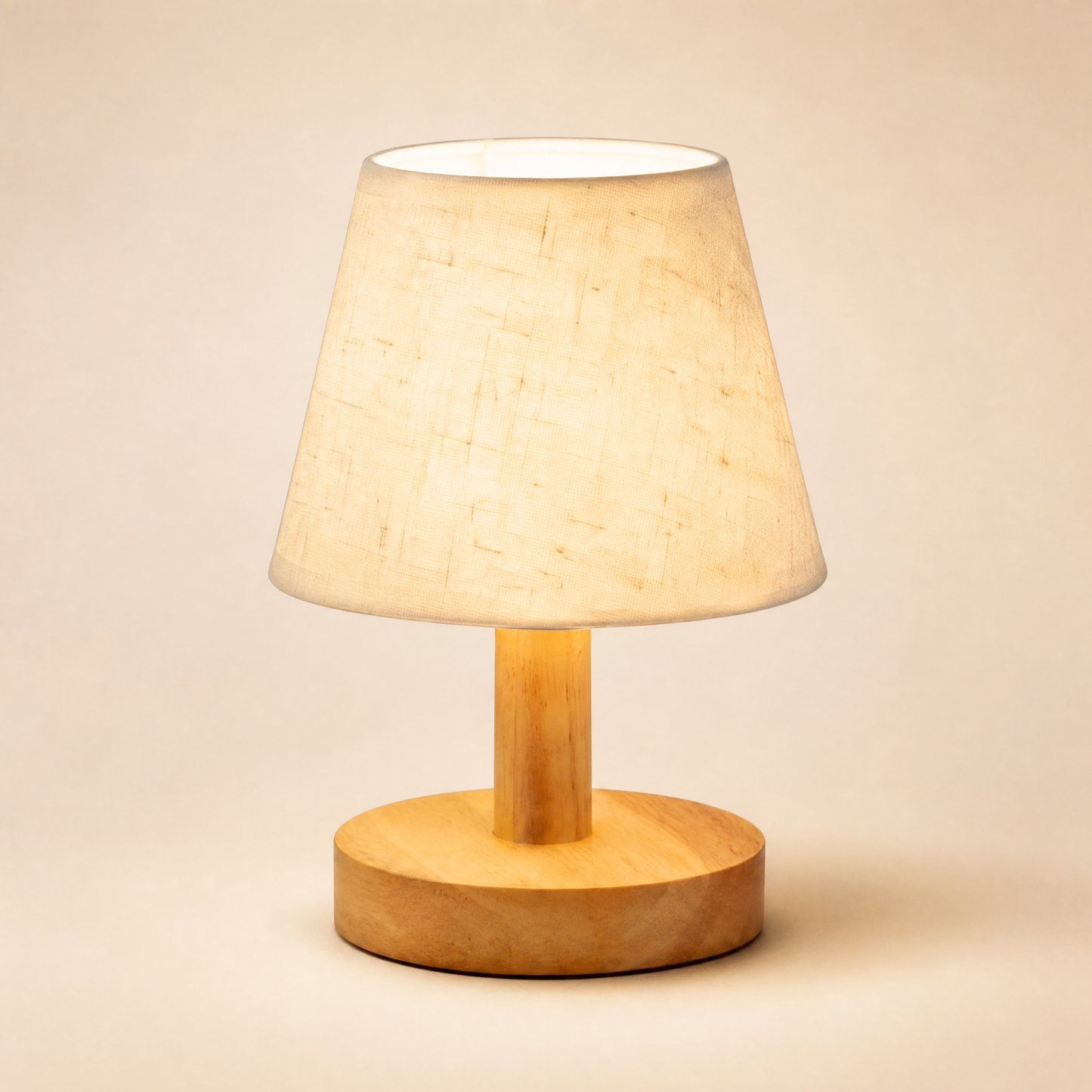 Glow oak bedside lamp with linen shade lit on warm cream backdrop