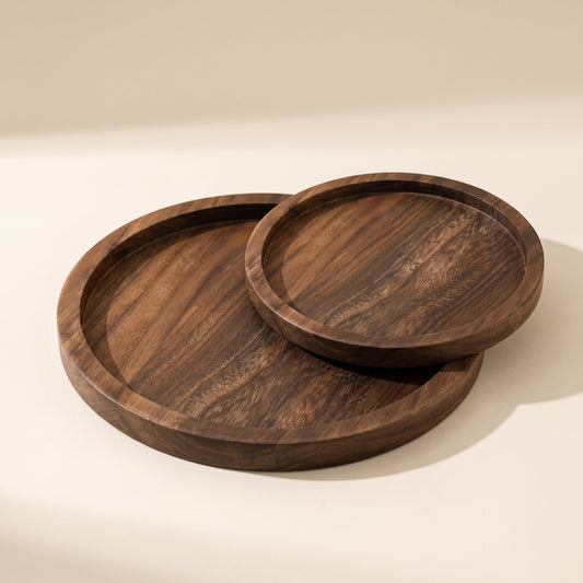 Timber™ Round Serving Tray — large and small walnut trays on warm cream background