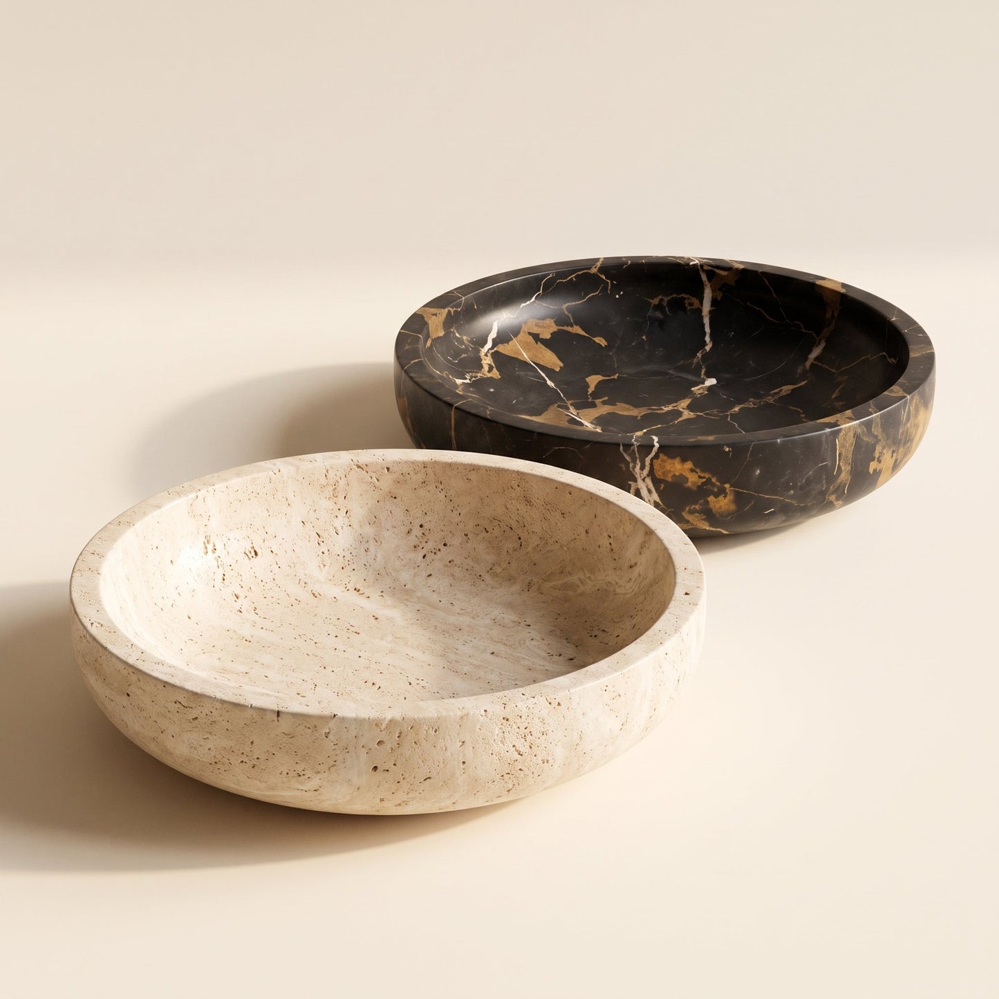 Quarry™ Marble Centerpiece Bowl — travertine and Nero Gold bowls on warm cream background