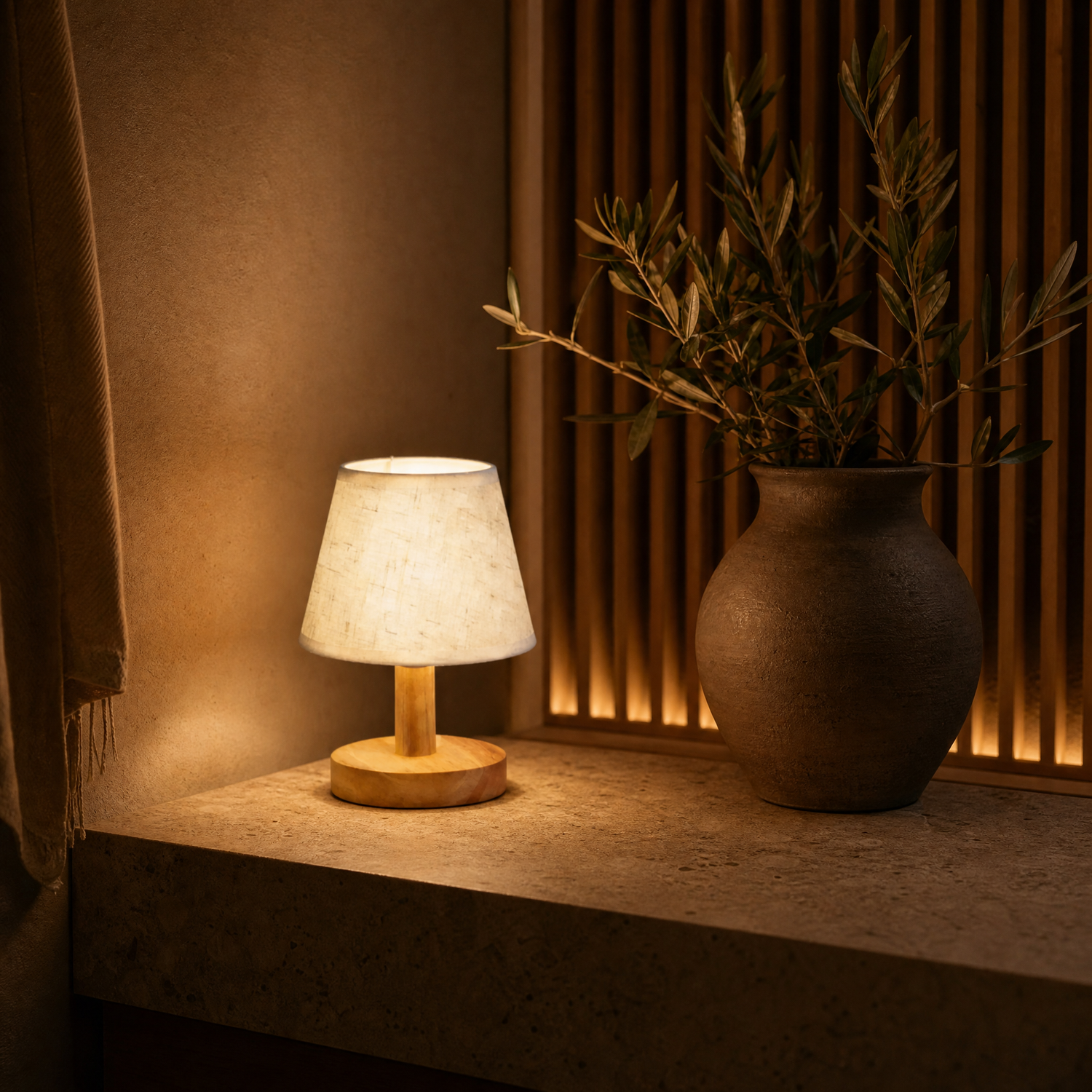 Glow lamp on stone console with clay vase and olive branches