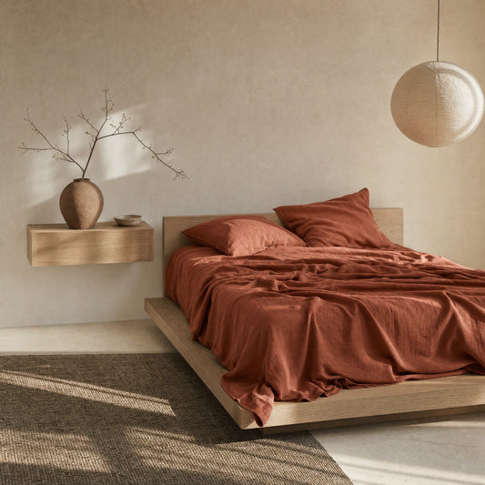 Clay linen flat sheet on oak platform bed in Japandi bedroom
