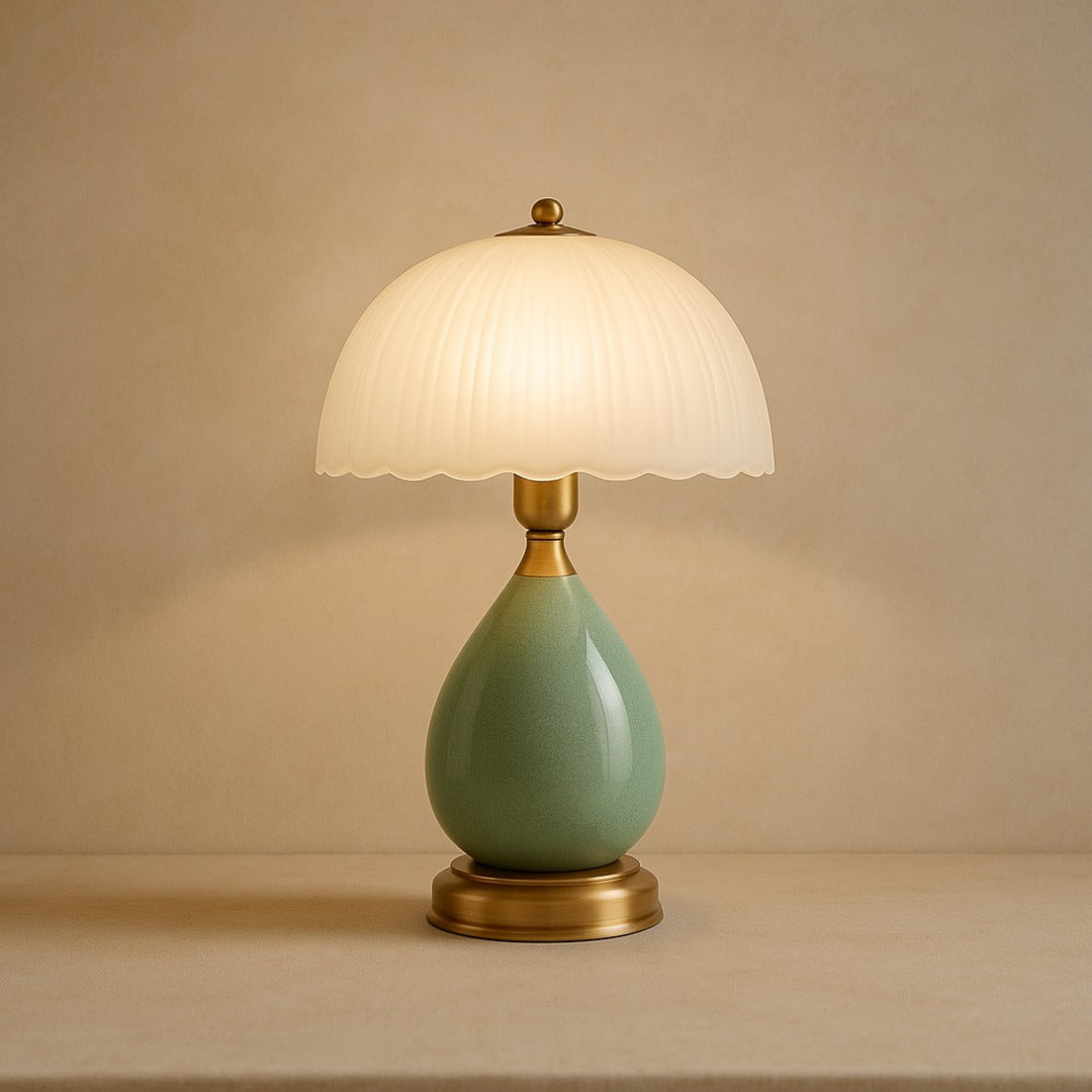 Petal ceramic table lamp with pleated glass shade on warm cream plaster
