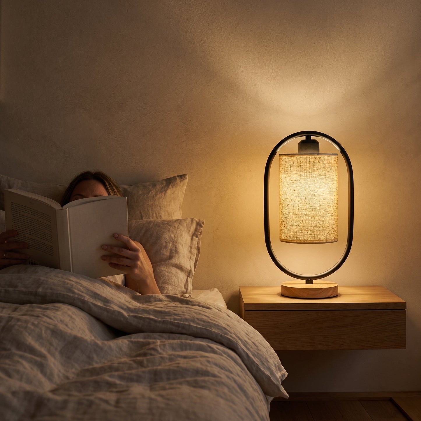 Reading in bed by the black Hoop™ Lantern Table Lamp