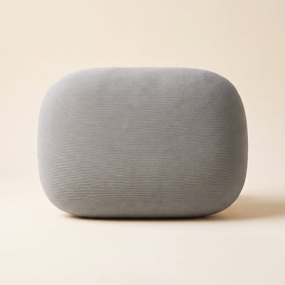 Doze™ Desk Nap Pillow — grey pebble-shaped memory foam pillow on warm cream background