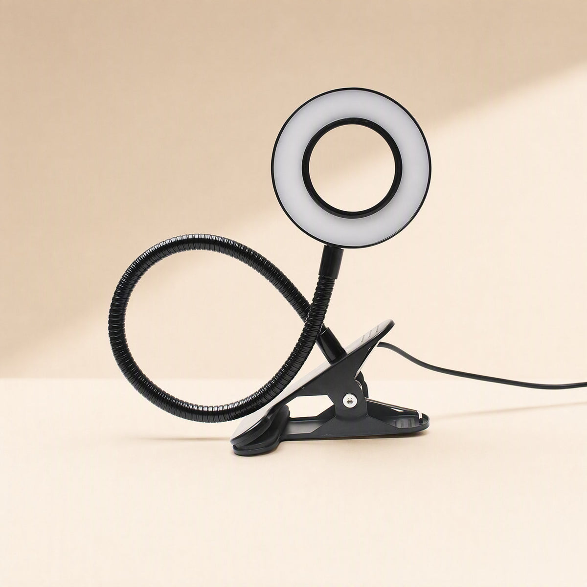 USB-powered clip-on table lamp with a metal shade and gooseneck form