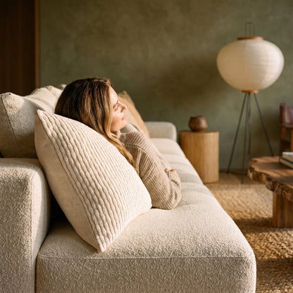 Lounging on the sofa against the ivory Weave™ Textured Cushion