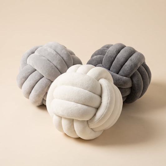 Knot™ Velvet Ball Cushion — ivory, cloud grey and charcoal knot cushions on warm cream background