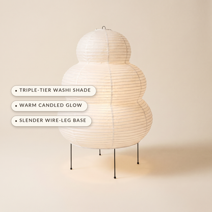 Cocoon™ Paper Table Lamp — triple-tier washi shade, warm candled glow, slender wire-leg base