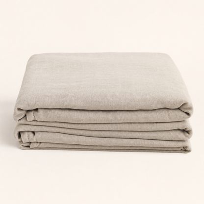 Flax oat French linen flat sheet folded on warm cream backdrop