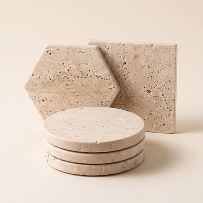 Strata™ Travertine Coaster Set — circle, hexagon and square coasters on warm cream background