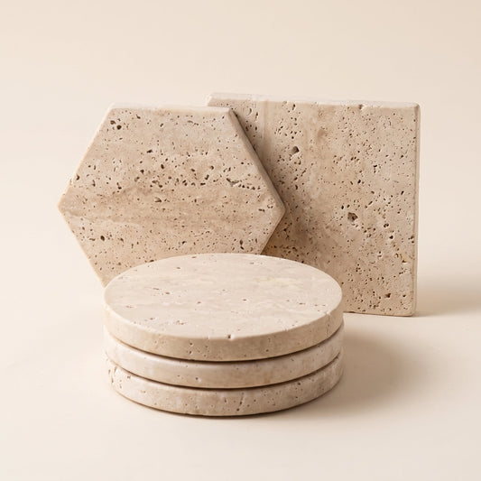 Strata™ Travertine Coaster Set — circle, hexagon and square coasters on warm cream background