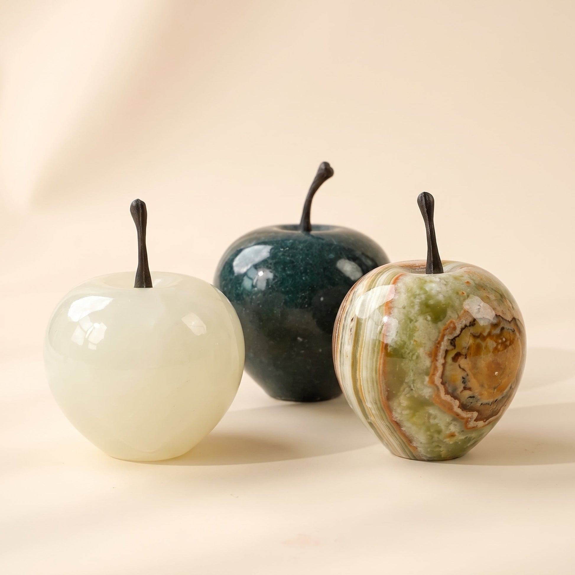Orchard™ Stone Apple — white jade, black marble and amber onyx apples on warm cream background