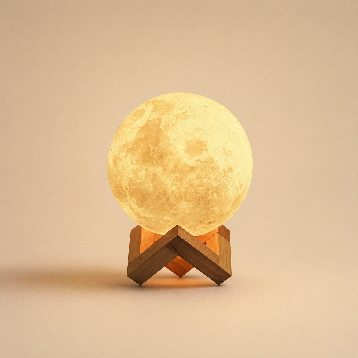 Luna moon night light glowing warm on beech cradle, warm cream backdrop