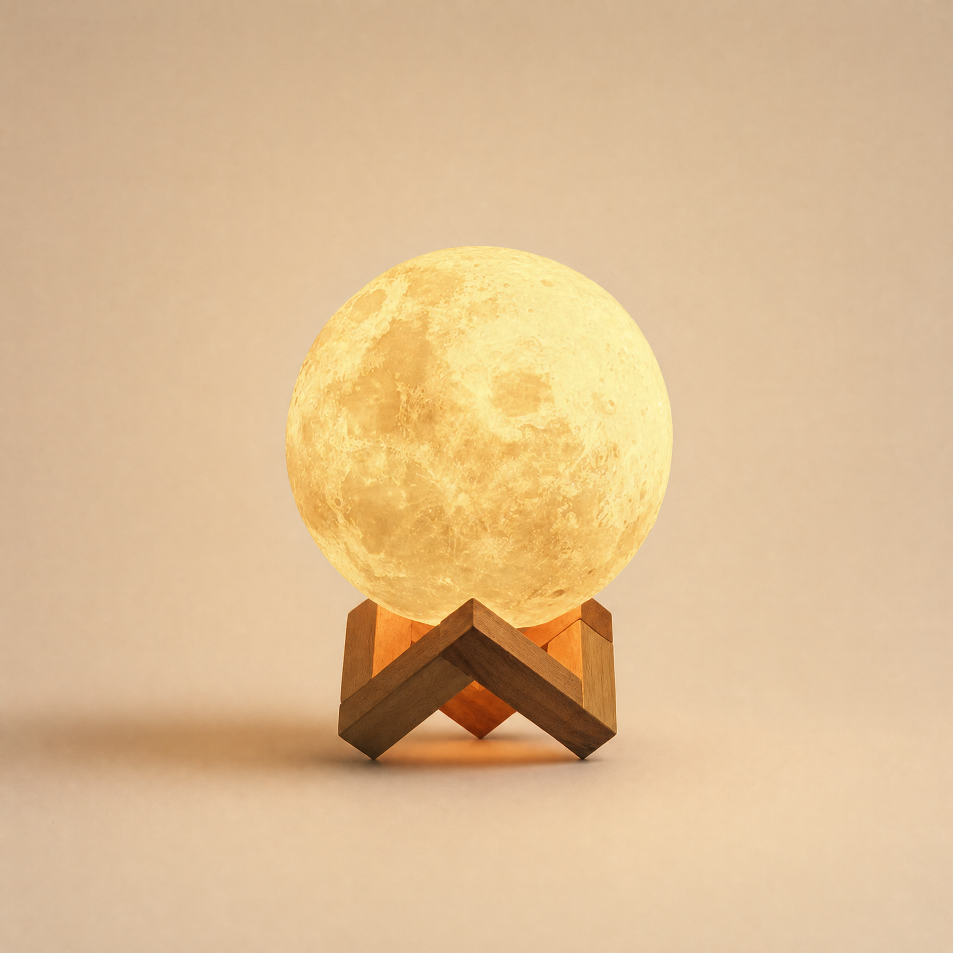 Luna moon night light glowing warm on beech cradle, warm cream backdrop