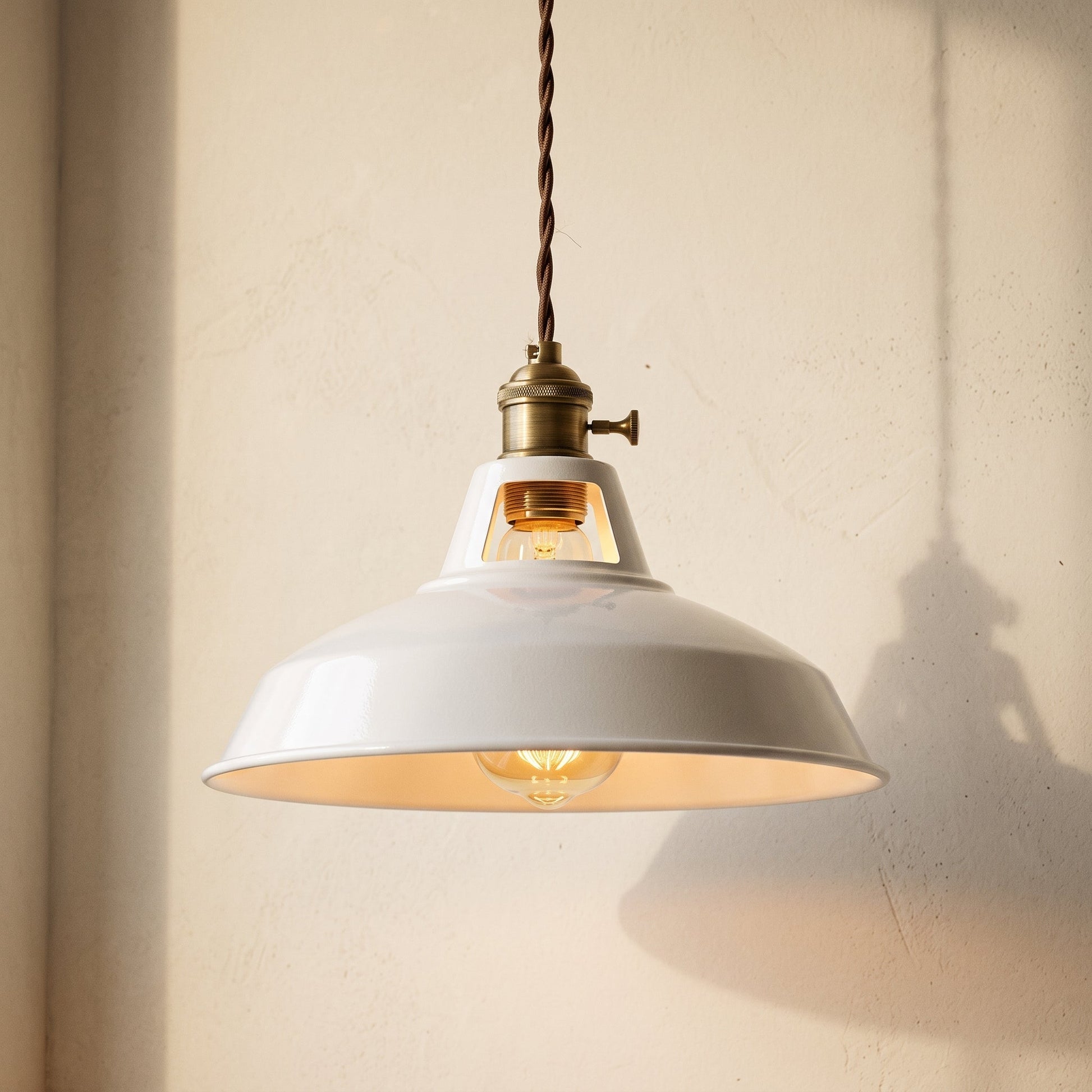Brim Pendant chalk white enamel barn dome shade hanging against a warm cream limewash wall