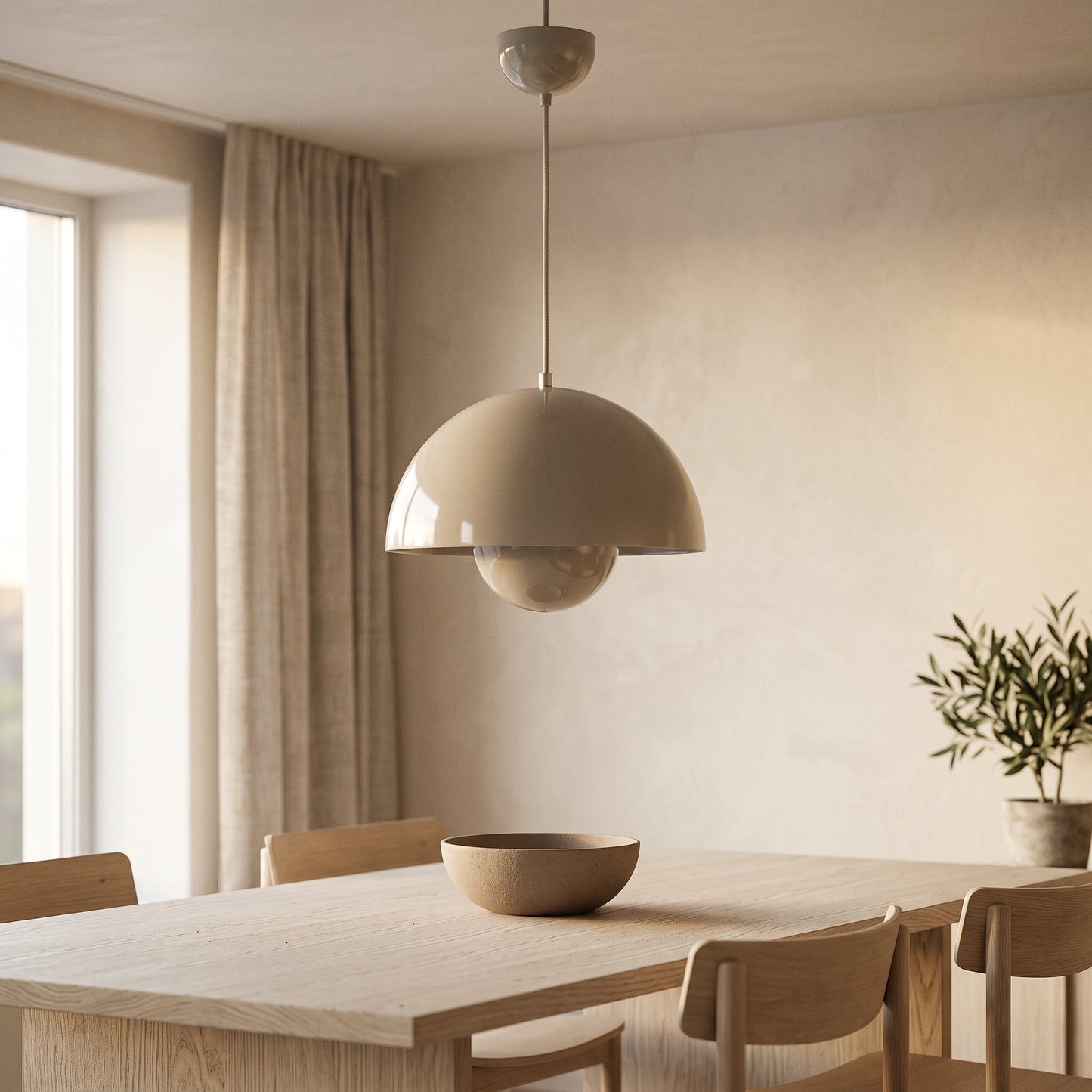 Bud pendant hanging over a pale oak dining table in a Japandi kitchen