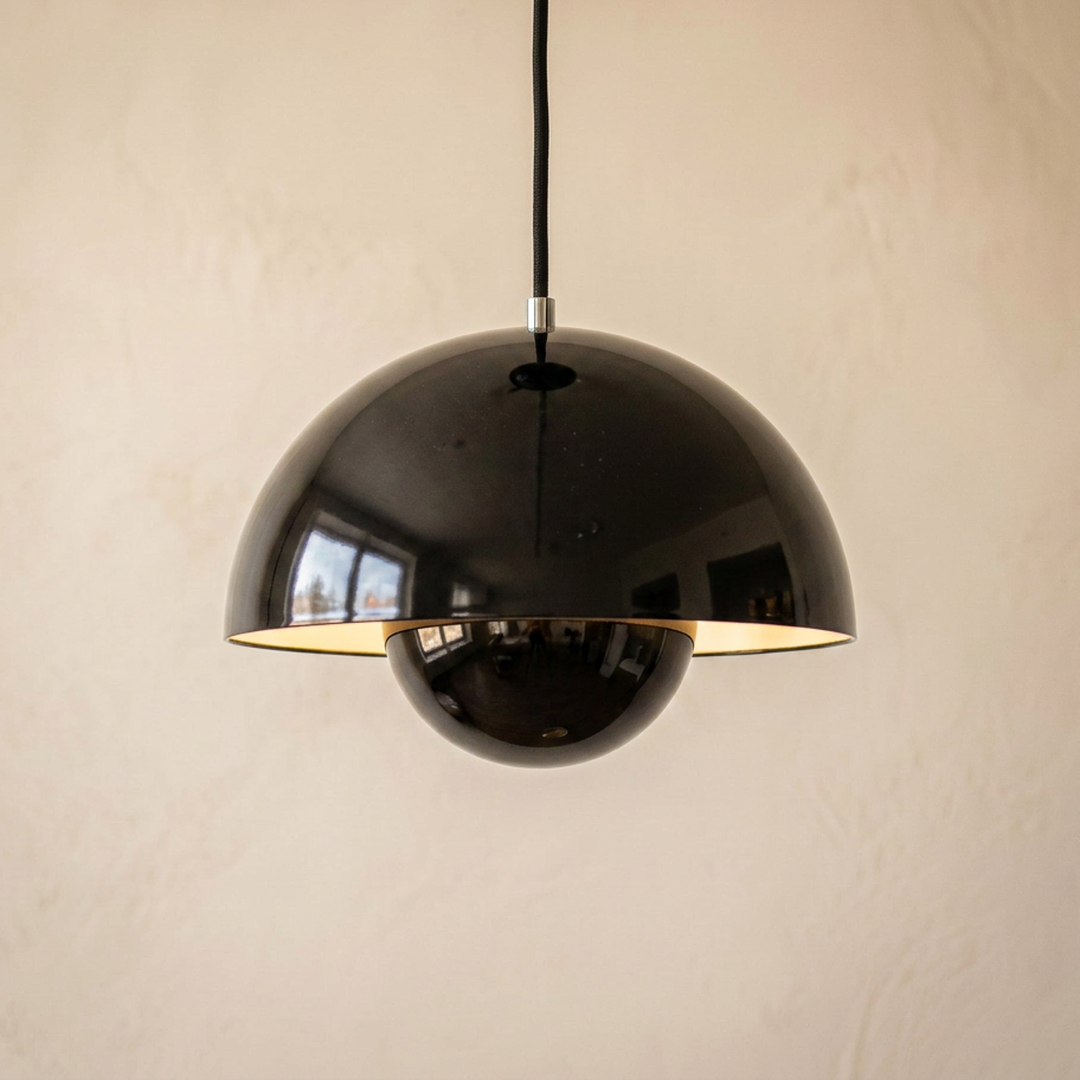 Bud pendant light in Onyx, a glossy black lacquer shade with a warm white lit interior