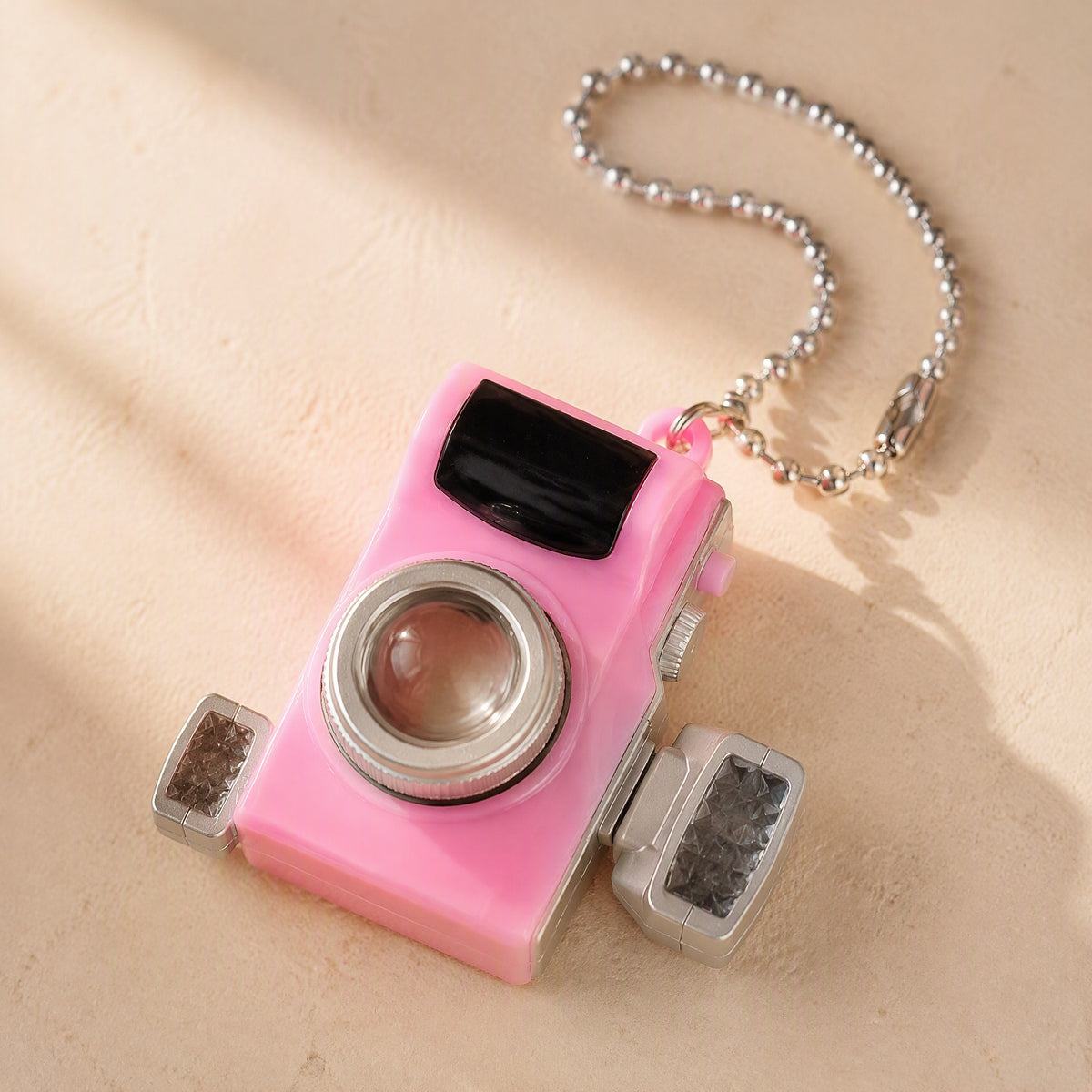 Snapcharm™ Plastic Mini Camera Pendant, material and detail close-up