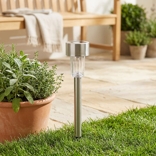 Lawnshine™ Stainless Steel Solar Lawn Light in a calm home setting