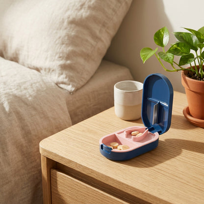 Dosecutter™ Portable Pill Box With Cutter in a calm home setting