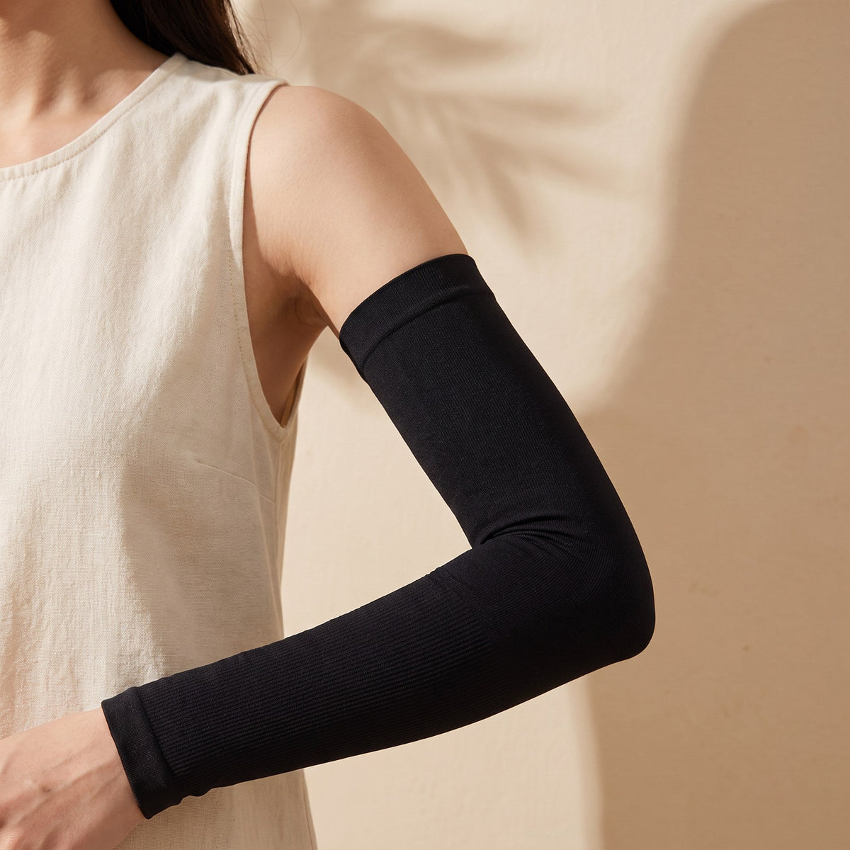 Haven Cooling Arm Sleeves in black, worn on the arm