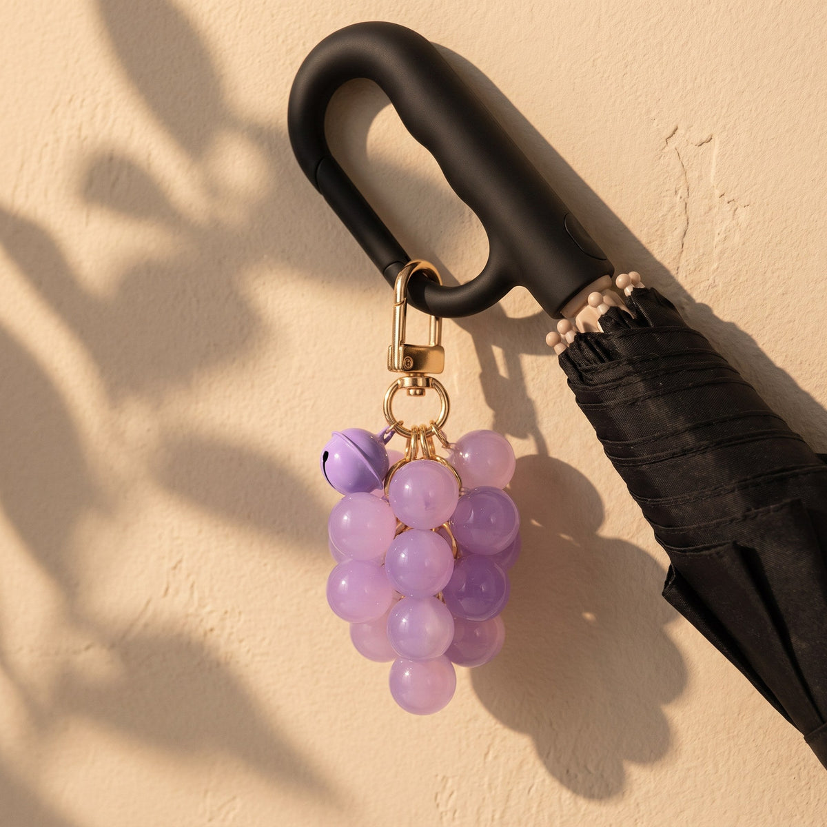 Haven UV Charm clipped to the Haven umbrella handle