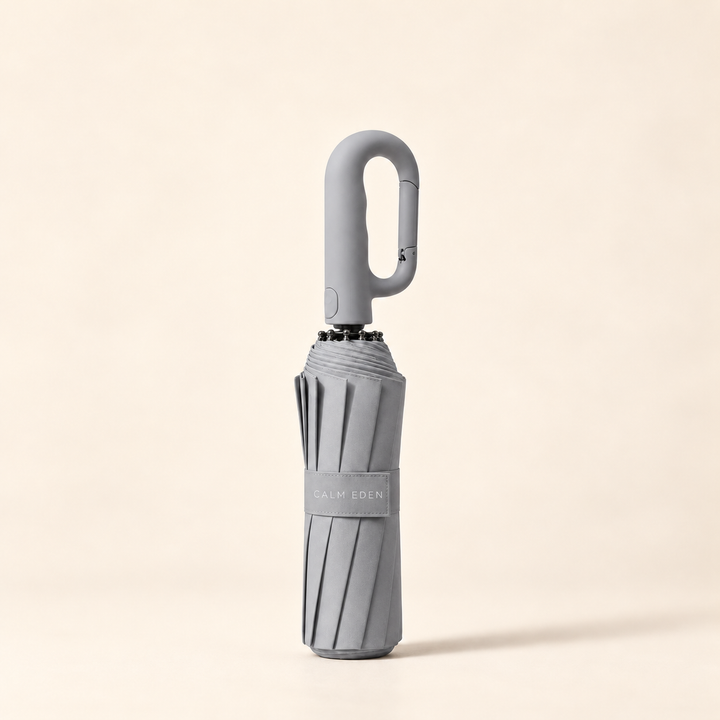 Folded gray Haven umbrella on a warm ivory background