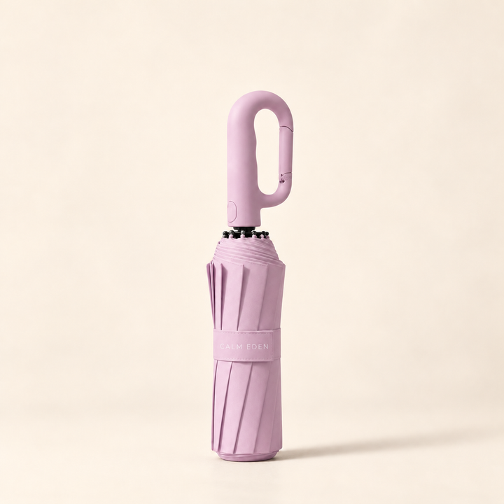 Folded pink Haven umbrella on a warm ivory background