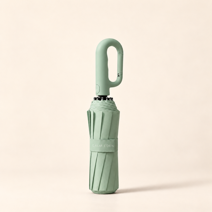 Folded green Haven umbrella on a warm ivory background