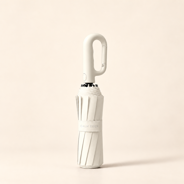 Folded cream Haven umbrella on a warm ivory background