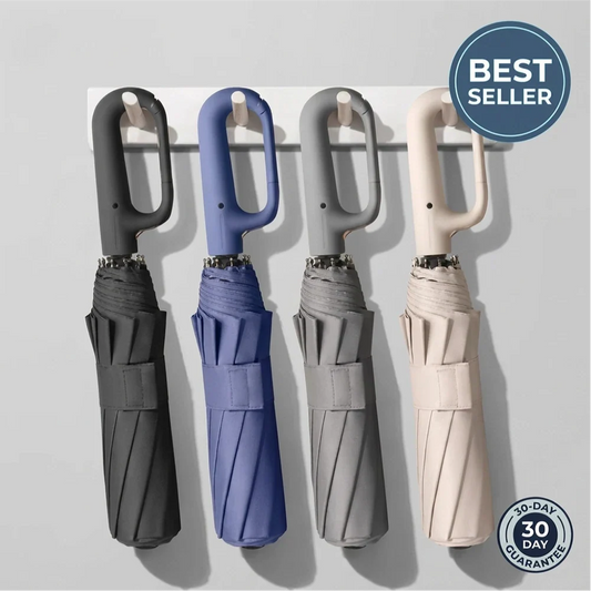 Four folded Haven umbrellas in gray, blue, grey-beige and beige hanging by their carabiner handles