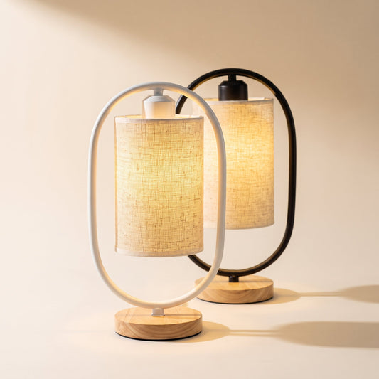 Hoop™ Lantern Table Lamp — white and black oval-hoop lamps glowing on warm cream background