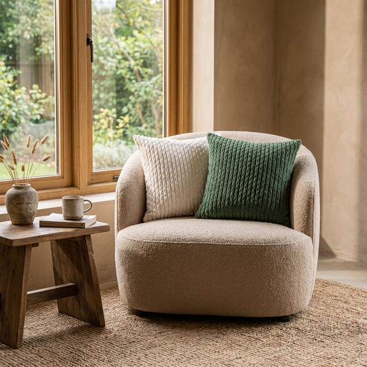 Weave™ Textured Cushion Covers on a bouclé armchair in a warm Calm Eden-style reading corner