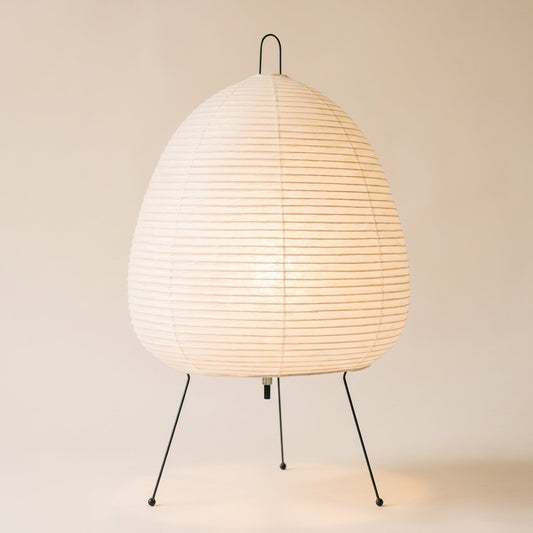 Washi™ Paper Lantern Lamp — rice-paper lantern on wire legs glowing on warm cream background