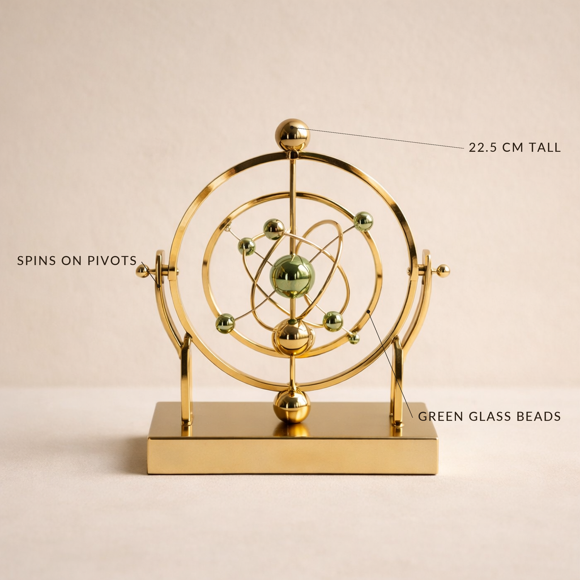 Kinetic sculpture labelled 22.5 cm tall, spins on pivots, green glass beads