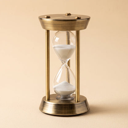 Ebb™ Sand Timer — antique brass frame with a hand-blown glass hourglass and white sand
