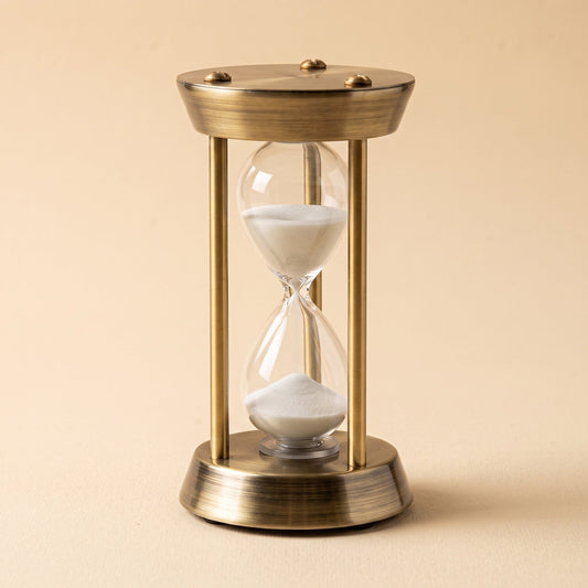 Ebb™ Sand Timer — antique brass frame with a hand-blown glass hourglass and white sand