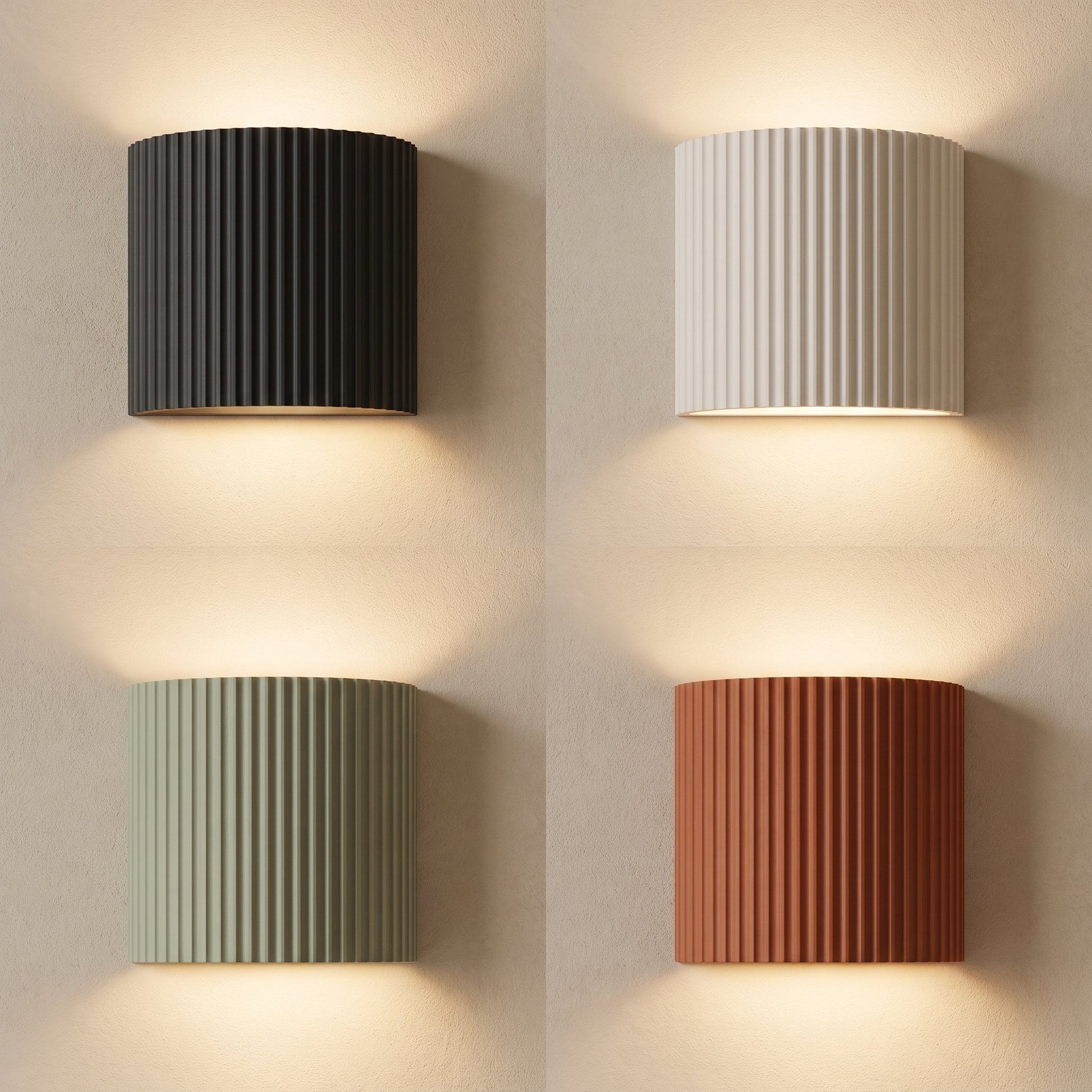 Flute fluted wall sconces in charcoal, white, sage and terracotta lit on warm cream plaster