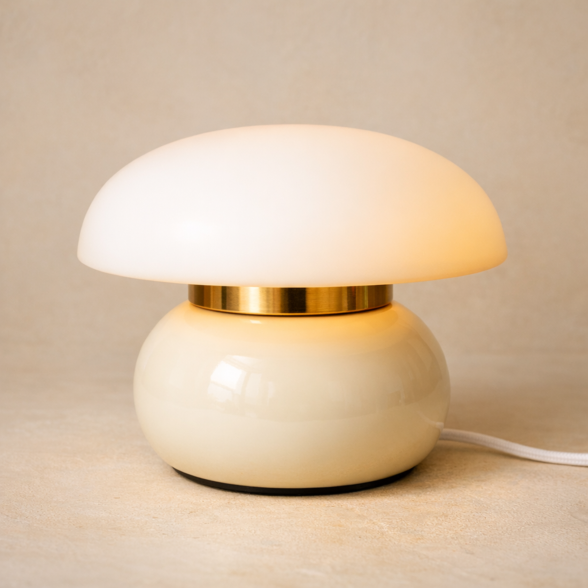 Pillar Dome Lamp in Cream White on warm cream plaster, opal dome glowing