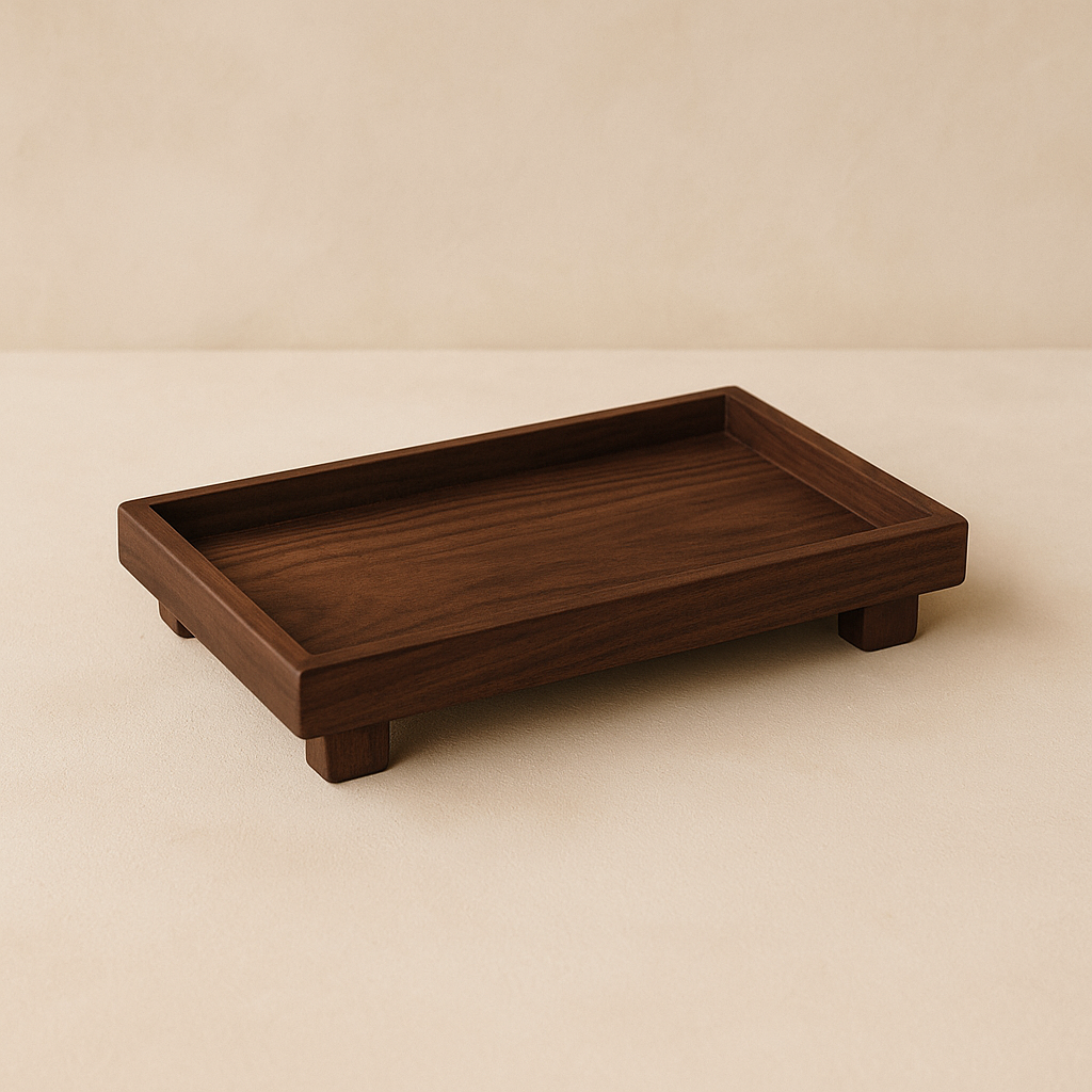 Plinth walnut serving tray on warm cream plaster — hero