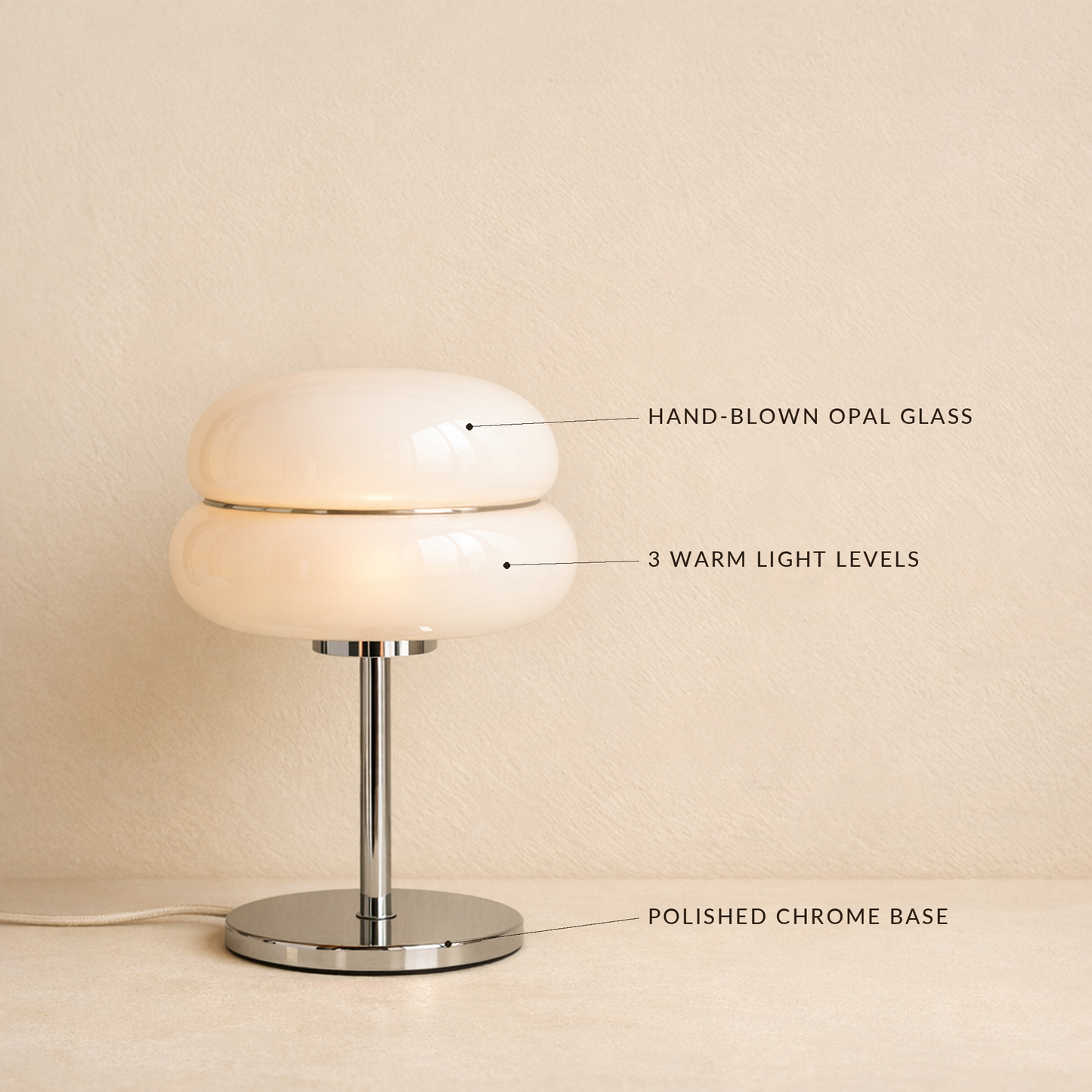 Sable lamp with labels marking the hand-blown opal glass, three warm light levels and polished chrome base
